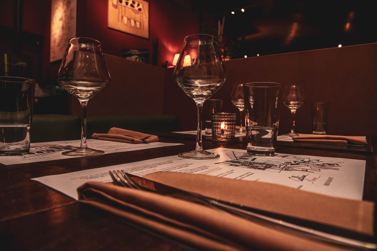 Romantic restaurant setting with candlelight and elegant tableware, perfect for fine dining ambience.